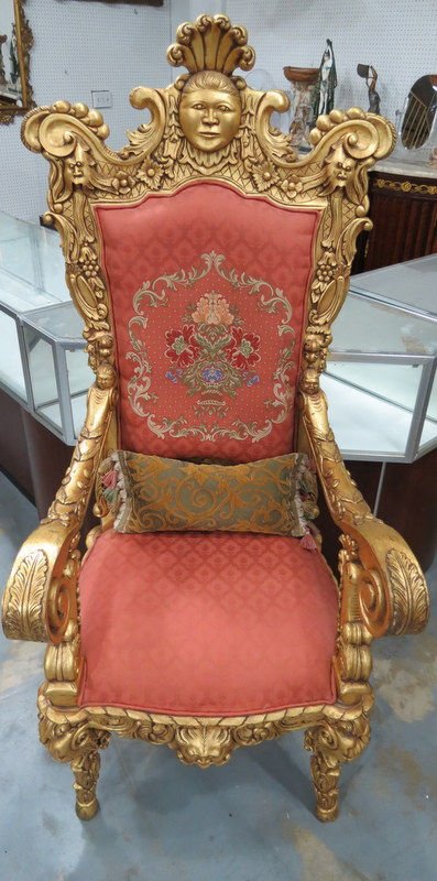 Ornate Gilt Carved Wooden Arm Chair: Vintage Ornate Gilt Carved Wooden Arm Chair. The seat and bake are upholstered in rust color with floral needle point on back and decorated with brass. Measures - 65" high x 24" wide.