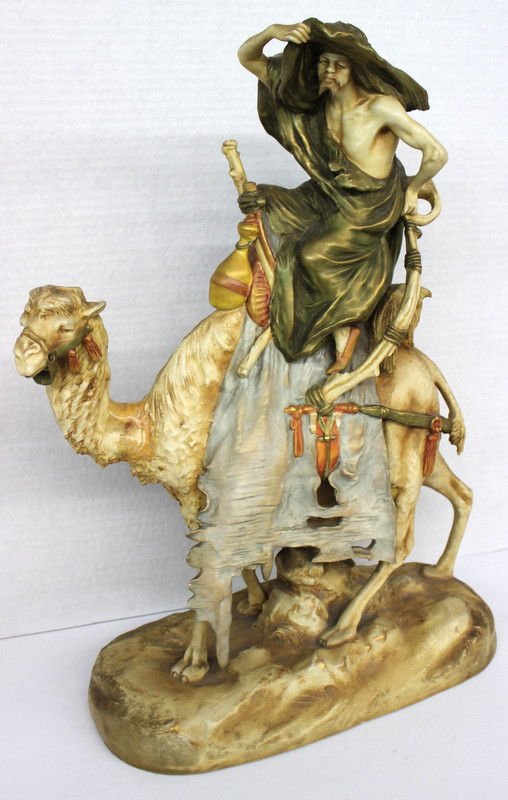 Austrian Amphora Hand Painted Porcelain of Man on Camel: Austrian Amphora Hand Painted Porcelain of Man on Camel. Measures - 20 1/2" high x 17" long. Some restoration on neck.