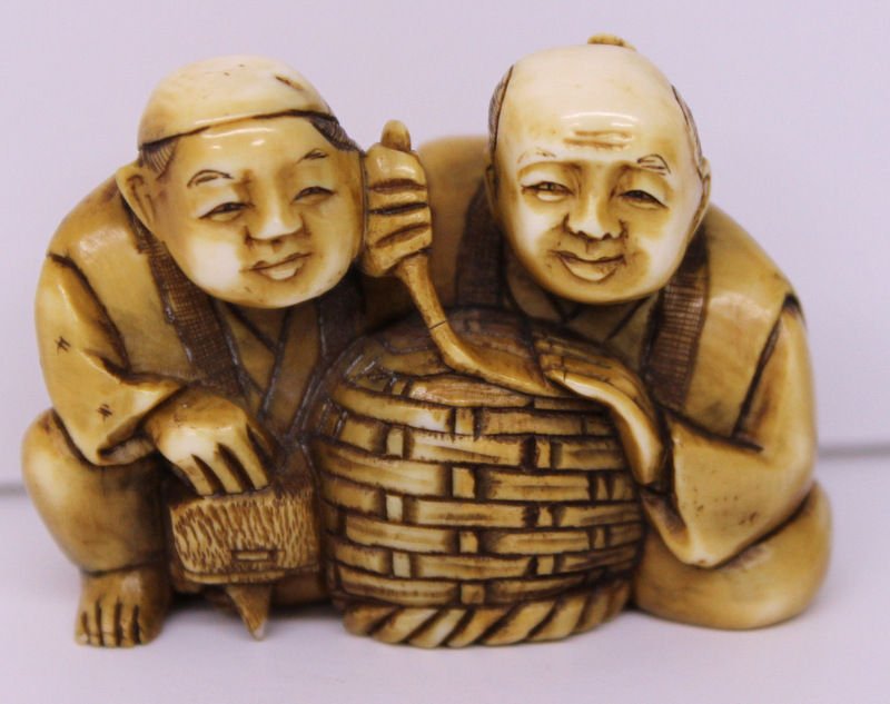 19th C. Japanese Carved Ivory Netsuke: 19th C. Japanese Carved Ivory Netsuke. Two figures with basket. Measures - 1 1/2" high x 2" wide. Weighs - 40.3 grams.