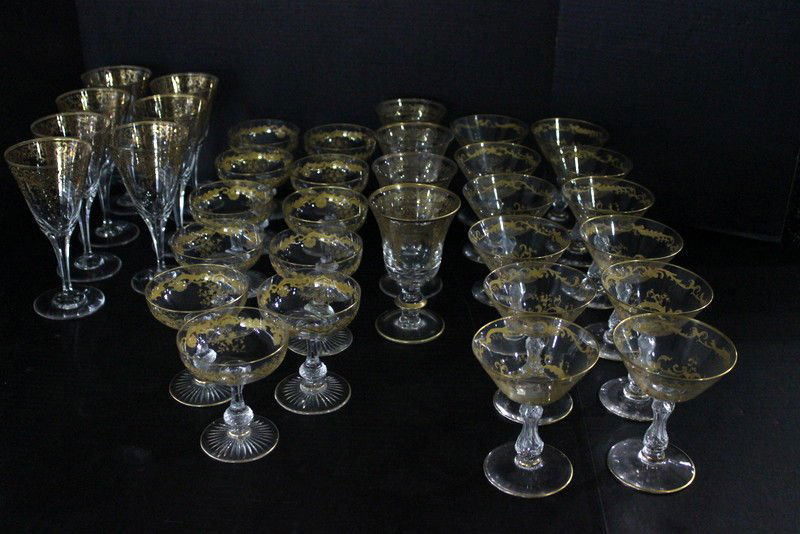 34 Pc. Magnificent Set of Gilt Glassware: 34 Pc. Magnificent Set of Gilt Glassware with raised gold design. 7 wine goblets - 7" high, 11 champagne glasses - 4 1/4" high, 4 water goblets - 5 5/8" high, 12 martini glasses - 4 1/8" high.