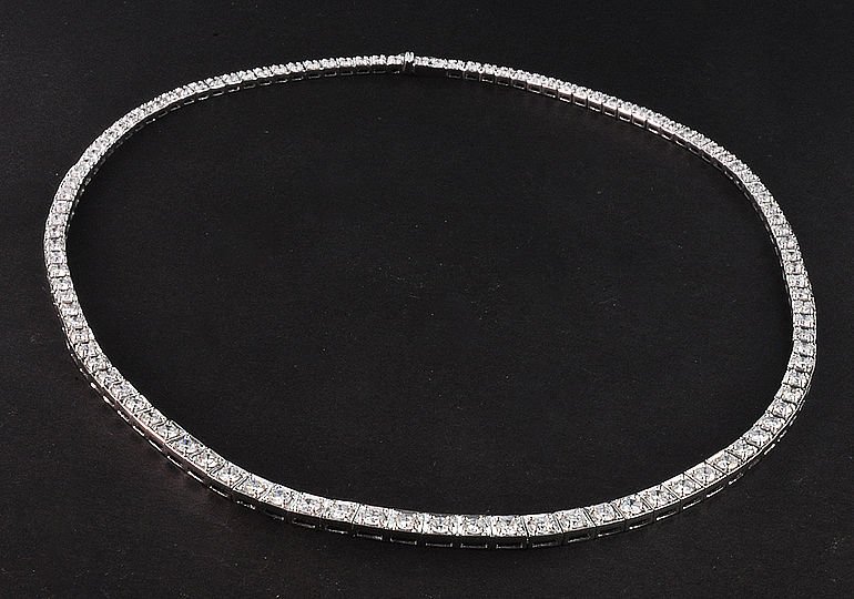 Contemporary 18K White Gold & Diamond Riviera Necklace: This is a contemporary 18K white gold and diamond Riviera necklace. The necklace features a graduating straight line design pave set with 108 round brilliant cut diamonds weighing 10.80cts. They a