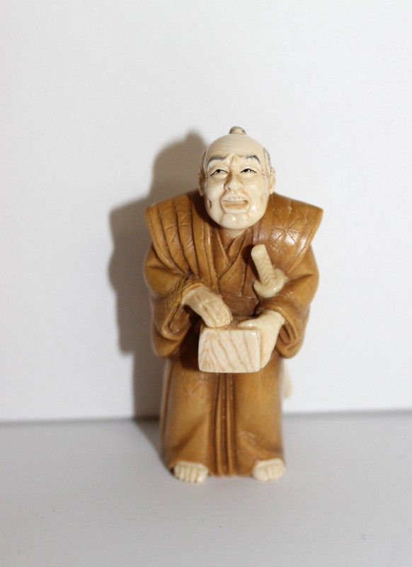 Rare Chinese Ivory & Wood Signed Netsuke: Rare Chinese Ivory & Wood Signed Netsuke, stamped with mother of pearl depicting man with sword. Measures - 2 3/8" high.