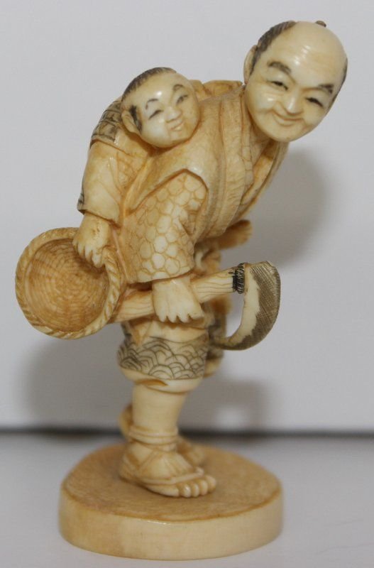 19th C. Japanese Carved Ivory Netsuke: 19th C. Japanese Carved Ivory Netsuke. Finely carved man with child and scathe in hand. Measures - 2 3/8" high. Weighs - 18.2 grams.