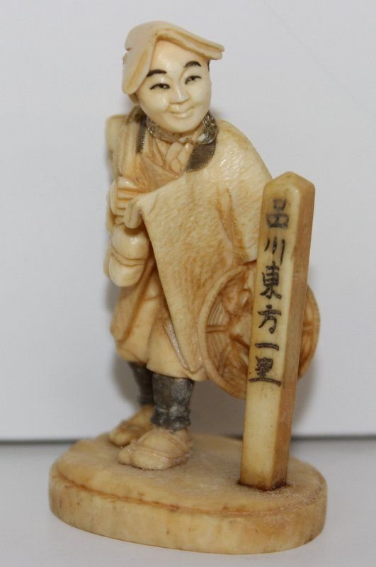 19th C. Japanese Carved Ivory Netsuke: 19th C. Japanese Carved Ivory Netsuke. Finely carved man with staff. Signed on bottom. Measures - 2 1/4" high. Weighs - 20.7 grams.