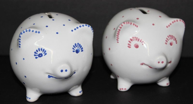 2 Retired Tiffany & Co. Polka Dotted White Piggy Banks: 2 Retired Tiffany & Co. Polka Dotted White Piggy Banks. One with pink dots, other with blue dots. Both marked Tiffany & Co. Measures - 3 3/4" high x 5" long. With original keys.