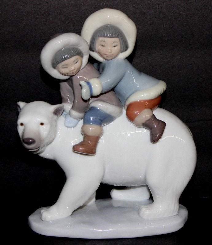 Lladro Porcelain Group 'Eskimo Riders" #5353: Lladro Porcelain Group 'Eskimo Riders" #5353. 2 little kids, issued - 1985. riding a polar bear. Measures - 7 1/4" high. Sculptor - Jose Puche.