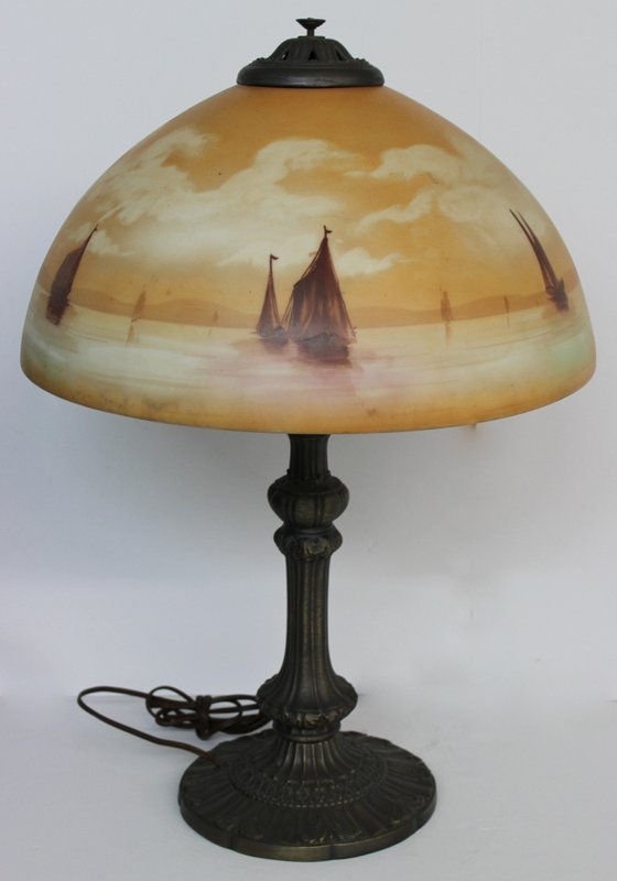 Scenic Painted Glass Shade w/ Bronze Base: Scenic Painted Glass Shade w/ Bronze Base. The shade is a nautical scene exhibiting rich tones of burnt orange, brown and light burgundy and green accents. Base - 22 3/4" high, shade - 15 1/2" diamete