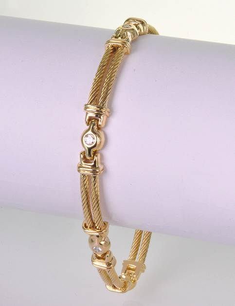 18Kt YG 0.25ct Diamond Bracelet by Philippe Charriol: 18Kt YG 0.25ct Diamond Bracelet by Philippe Charriol. The bracelet features a sectional double row design interspersed with 5 round brilliant cut diamond spacers that weigh approx. 0.25cts. They are f