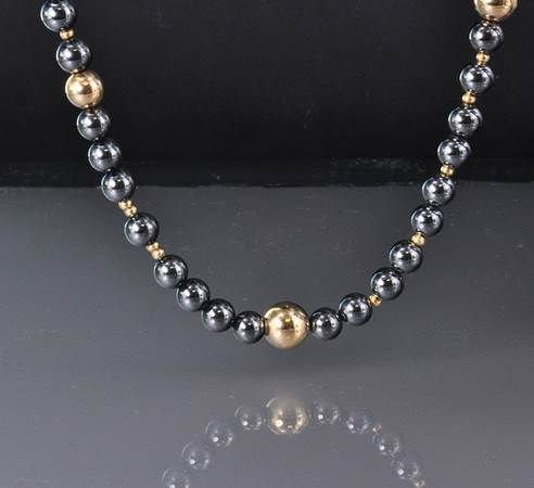 Tiffany & Co. Gold & Hematite Bead Opera Length: Tiffany & Co. Gold & Hematite Bead Opera Length Necklace featuring an extra long single strand endless design strung with alternating yellow gold and hematite beads measuring 34" long. Accompanied wit