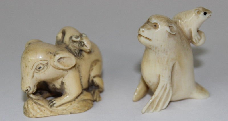 Carved Ivory Netsukes w/ Animals on Their Backs (2): Carved Ivory Netsukes w/ Animals on Their Backs (2). Weighs - 38.0 grams. Measures - 1 3/4" high x 1 3/4" long.