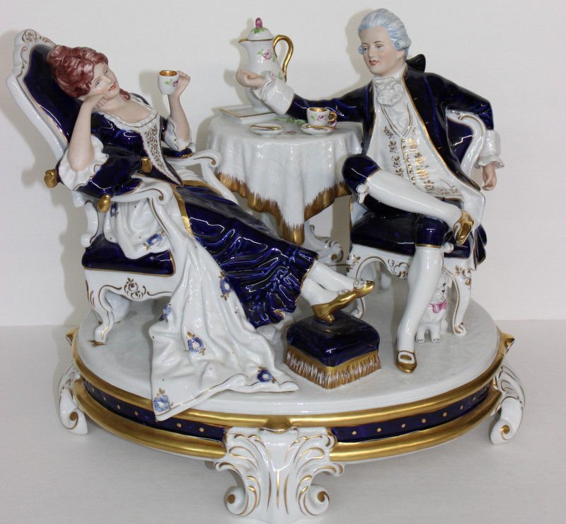 Massive Royal Dux Porcelain Group: Massive Royal Dux Porcelain Group. Featuring a couple enjoying tea. Measures - 13" high x 16" wide.