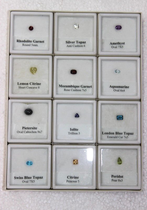 Collection of 12 Loose Framed Gemstones: Collection of 12 Loose Framed Gemstones. Collection consists of rhodolite garnet - round 5mm, silver topaz - anti cushion 6, amethyst - oval 7x5, lemon citrine - heart concave 8, mozambique garnet - r