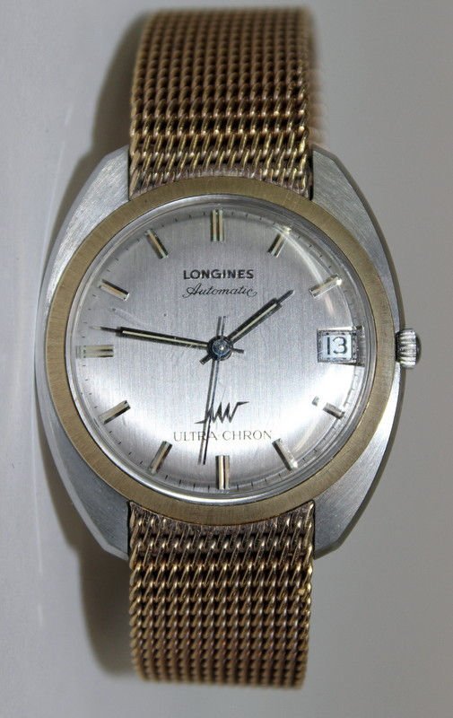 MENS LONGINES ULTRA-CHRON AUTOMATIC WRIST WATCH: Fine Mens longines Ultra-Chron Automatic Wrist Watch Circa 1960's. Fine Mens steel wrist watch by the longines watch co in a one piece tonneau shaped case framed with solid 14K yellow gold bezel. High