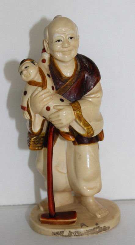 Japanese Carved Ivory Polychrome Elder Group: Japanese Carved Ivory Polychrome Elder Group featuring old man holding a child. Weighs - 170 grams. Measures - 5" high. INTERNATIONAL CLIENTS ARE INELIGIBLE TO BID ON THIS ITEM. THIS ITEM IS FOR SALE 