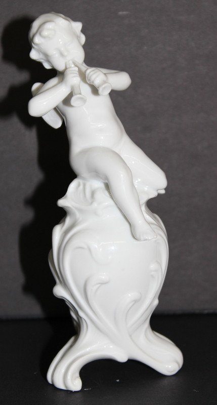 Capodimonte/Ginori Cherub Porcelain Figure: Capodimonte/Ginori Cherub Porcelain Figure. Depicting cherub playing instruments. Measures - 6 1/4" high.