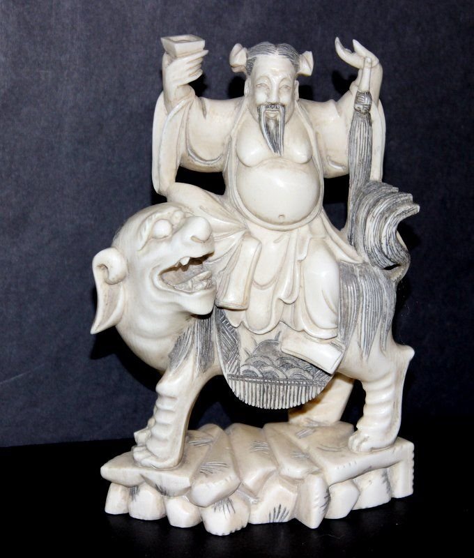 Early 20th C. Chinese Carved Ivory Foo Dog Group: Early 20th C. Chinese Carved Ivory Foo Dog Group. Featuring a woman riding a foo dog. Measures - 5 1/4" high x 3 3/4" wide. Weight - 329.3 grams. INTERNATIONAL CLIENTS ARE INELIGIBLE TO BID ON THIS IT