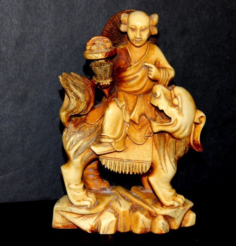 19th C. Chinese Finely Carved Ivory Foo Dog Group: 19th C. Chinese Finely Carved Ivory Foo Dog Group. Featuring a woman riding a foo dog. Measures - 5 1/4" high x 3 1/2" wide. Weight - 323.3 grams. INTERNATIONAL CLIENTS ARE INELIGIBLE TO BID ON THIS I