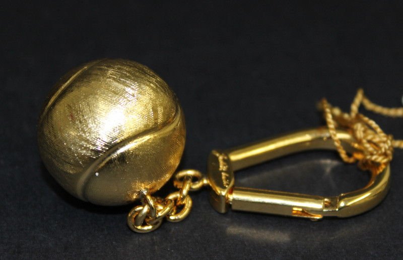 Judith Leiber Tennis Ball Key Chain: Judith Leiber Tennis Ball Key Chain. Measures - 3 1/2" long. Weight - 24.6 grams.
