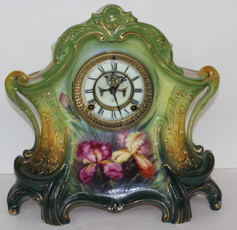 German Royal Bonn Mantle Clock: German Royal Bonn Mantle Clock. La Lavon Model, Ogee shape, with raised, molded crest, with two scroll-rolled handles to either side. Measures - 14" high x 15" long x 5" wide.