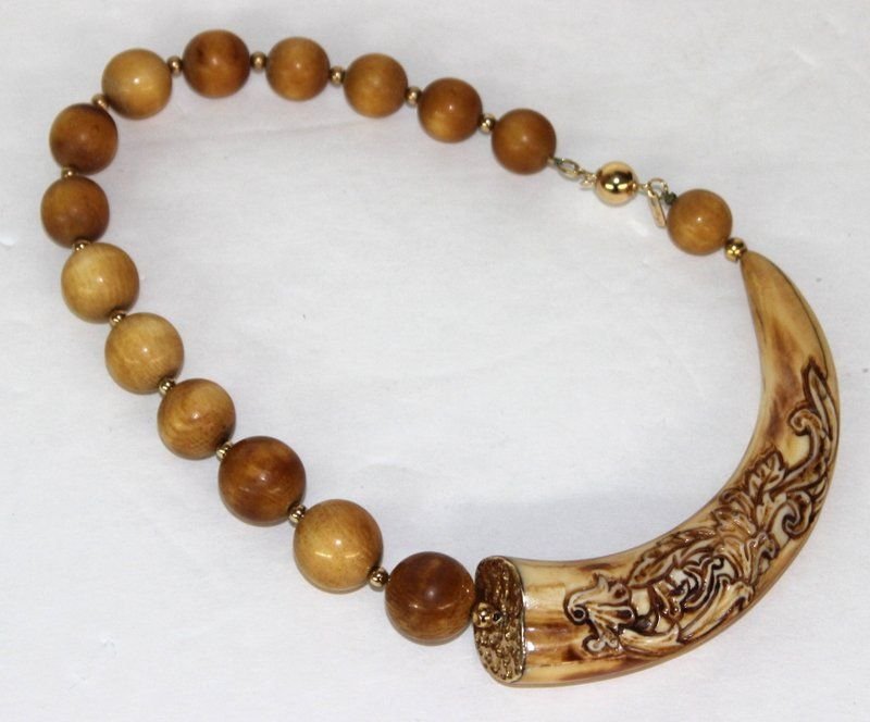 14Kt YG Boars Tusk Ivory Necklace: 14Kt YG Boars Tusk Ivory Necklace. Weight - 100.3 grams. INTERNATIONAL CLIENTS ARE INELIGIBLE TO BID ON THIS ITEM. THIS ITEM IS FOR SALE ONLY WITHIN THE UNITED STATES, EXCEPT NOT TO CALIFORNIA, NEW YO