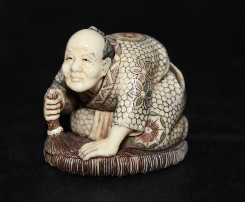 Japanese Finely Carved Ivory Netsuke: Japanese Finely Carved Ivory Netsuke. Featuring man brushing floor. Weight - 47.8 grams. Measures - 1 1/2" high. INTERNATIONAL CLIENTS ARE INELIGIBLE TO BID ON THIS ITEM. THIS ITEM IS FOR SALE ONLY WI