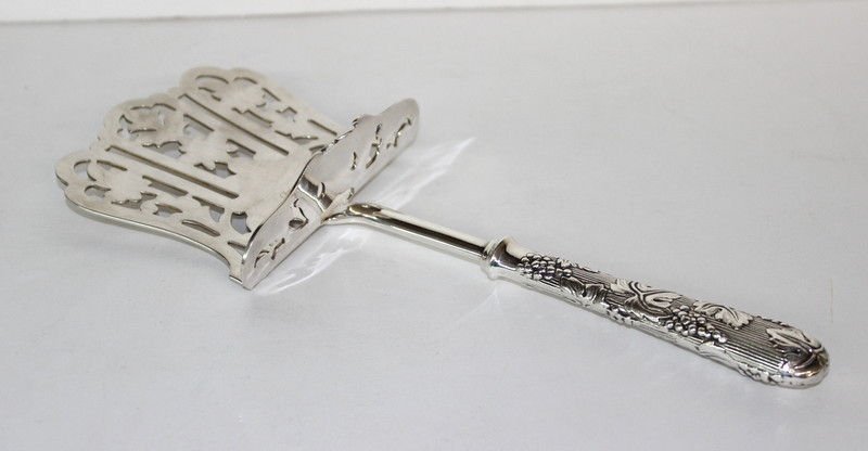 Christofle Paris Silver Serving Piece: Christofle Paris Silver Serving Piece with grapevine design on handle. Comes with original box. Measures - 10 1/4" long.