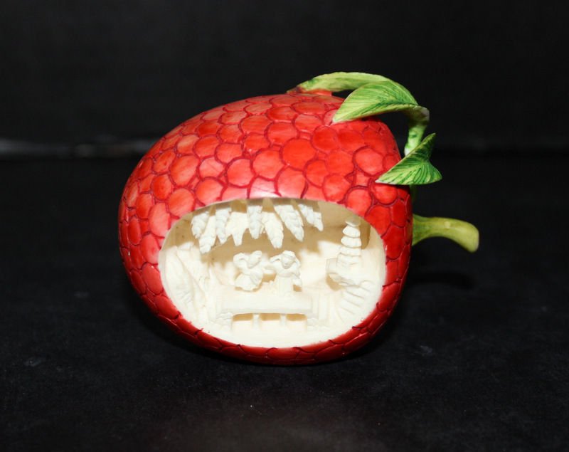 Chinese Intricately Carved Ivory Polychromed Strawberry: Chinese Intricately Carved Ivory Polychromed Strawberry. Measures - 2 1/2" high x 3 1/2" long. Depicting a village scene. Leaves are as is. Weight - 177.8 grams. THIS LOT IS EARLY 20TH CENTURY, OR EAR