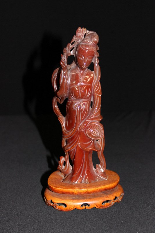 Chinese Carved Carnelian Quan Yen: Chinese Carved Carnelian Quan Yen. Mounted on wooden base. Measures - 9 1/2" high x 4 3/4" wide.
