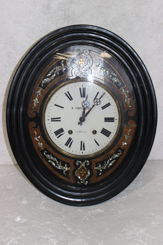 Antique E. Coquevelle MOP Insert Wall Clock: Antique E. Coquevelle MOP Insert Wall Clock. As is. Roman Numeral dial. Measures - 22 1/2" high x 18 5/8" wide.