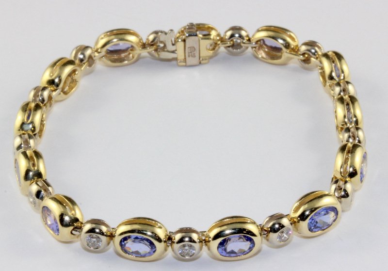 14Kt YG & WG, Diamond & Tanzanite Bracelet 11.50cts.: 14Kt YG & WG, Diamond & Tanzanite Bracelet 11.50cts. The bracelet features a sectional alternating design bezel set with 13 oval faceted tanzanite's that weigh 10.00cts. They are flanked with 13 round