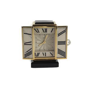 Cartier 18k Gold Miniature Table Clock: A rare 18k gold cased miniature table clock by Cartier. Made in Switzerland, c1935. Manual wind movement with Cartier calibre in hour and minute. Base and upper case made of onyx stone and wing clasp