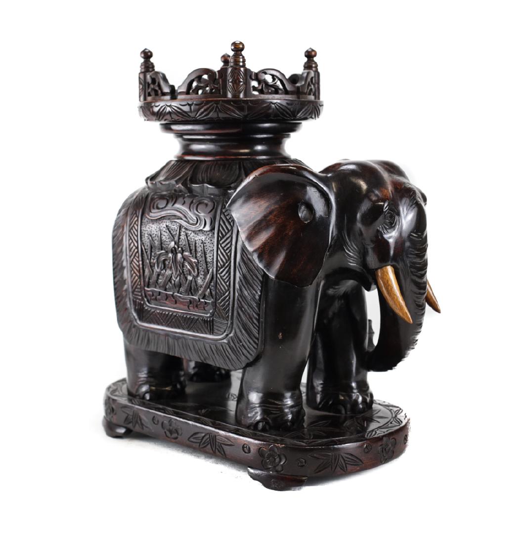 Carved Wood Elephant Form ivory Tusk Stand: A Chinese wood carved stand or base in the form of an intricately carved elephant, likely used as the base for a large ivory tusk or vase. From a prominent Sherman Oaks Estate that started purchasing 