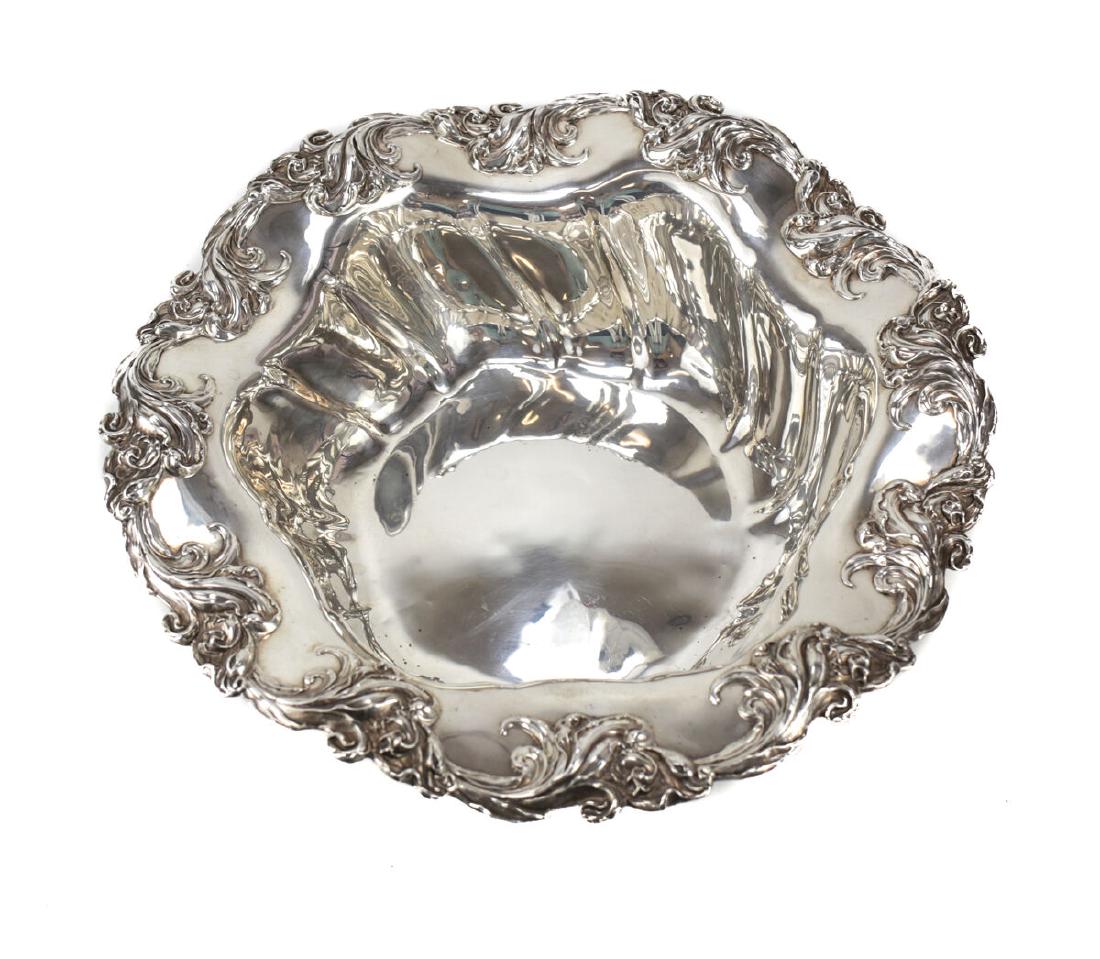 Mauser Mfg Co Sterling Silver Bowl: A sterling silver serving bowl by Mauser Mfg Co. Pattern #805B, circa 1900. Scallop rimmed with applied foliate leaves and florals around the edge. Marked to the underside. Weight: 24.51 ozt Measures: