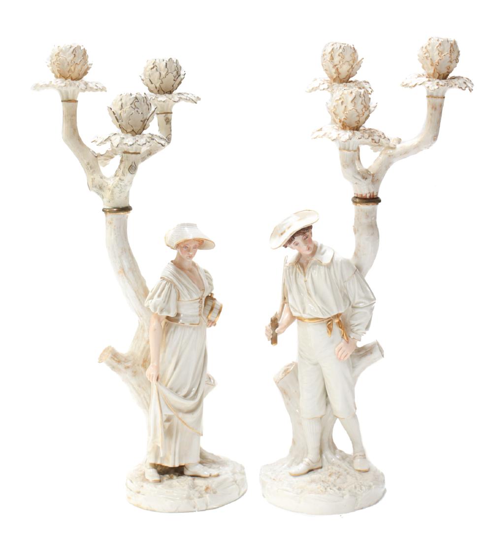 Pair Royal Worcester James Hadley Candelabras: A pair of Royal Worcester hand painted figural 3-light candelabras, designed by James Hadley. Measures: 21 inches tall Domestic Shipping: Please inquire