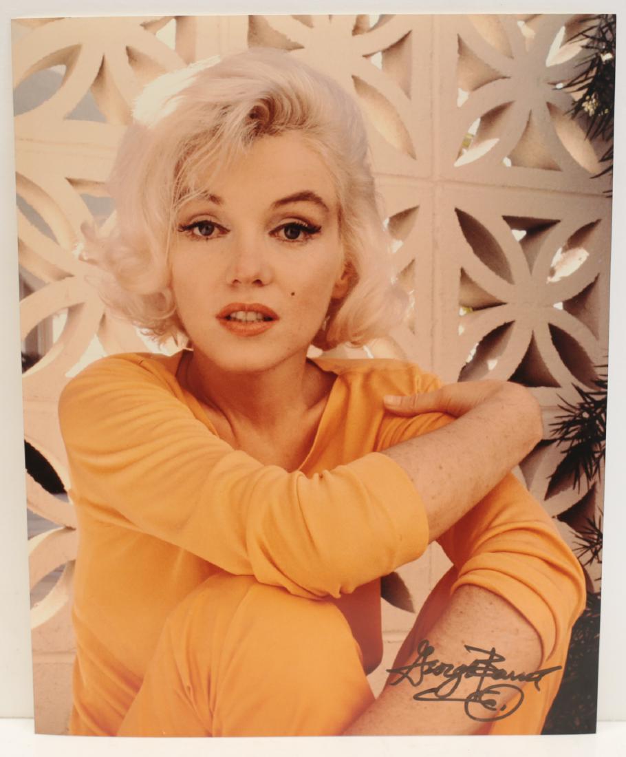 Marilyn Monroe Photograph George Barris: A limited edition George Barris photograph of Marilyn Monroe, depicting Marilyn Monroe posing wearing orange top. Signed by George Barris in marker (lower right). Stamped and numbered 24/35 on reverse