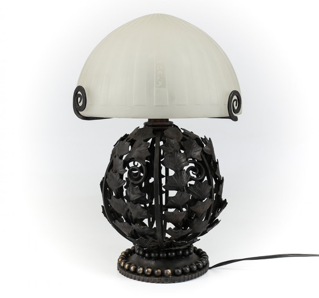 Art Deco Daum Acid Etched Lamp Hand Wrought Iron Base: A domed art deco acid etched lamp shade by Daum Nancy, France sitting on an elaborate hand wrought black patinated iron base. Wheel carved signature to the shade, Daum Nancy.Measures: 8 x 11" base, 9