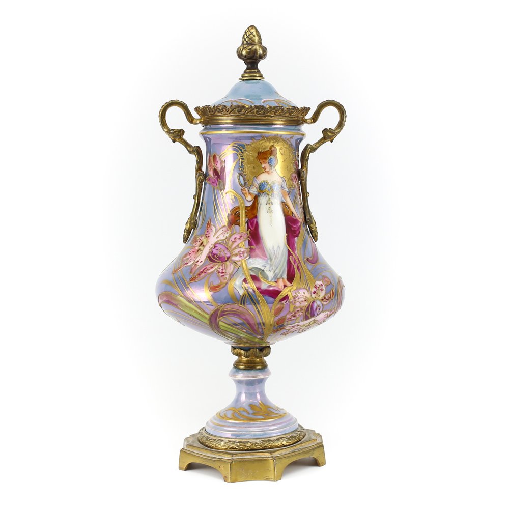 Sevres Porcelain Bronze Footed Iridescent Vase: A French Sevres blue porcelain and bronze footed vase decorated in floral and gilt. Featuring a hand painted muse holding a vanity mirror. Bronze acorn finial on lid., with adorned bronze handles. Rar
