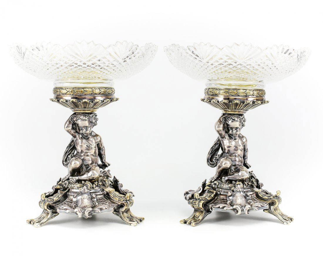 Pair of 19th Century Christofle Silver Plate & Crystal: A stunnng pair of Christofle, France compotes. Each having a fitted hand cut crystal top, a cherub stem sitting on a bed of roses, set on shielded base. Gold wash accents to the feet, roses and rim en