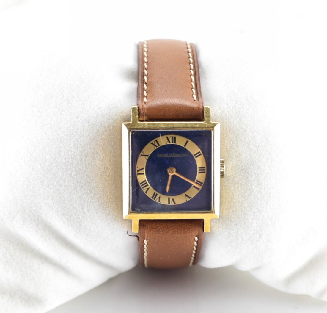 Jaeger Le Coultre 18K Gold Watch: 18k yellow gold square Jaeger Le Coultre watch. Roman numeral face with blue lapis back. Salvatore Ferragamo brown leather band. Measures: Case 20mm x 20mm Domestic Shipping: $40