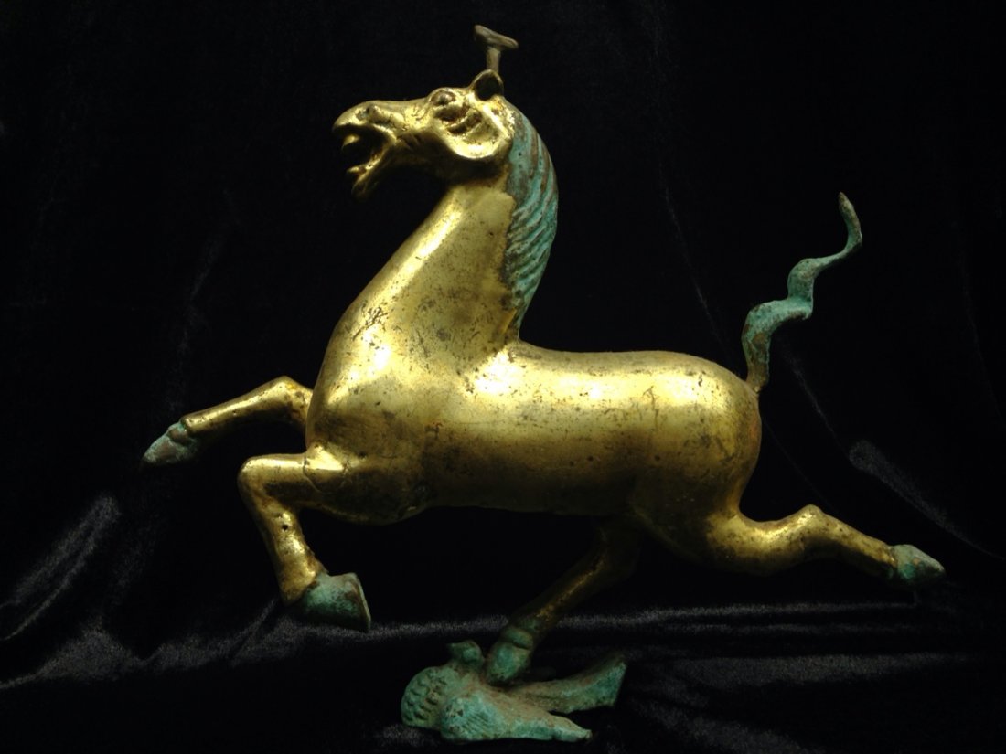 Han Dynasty Running Horse on a Swallow Gold and Bronze: Measurements: 29cm*25cm (9.8" * 11.4"); Age: Han dynasty 25-220. Running horse on a swallow. Made of gold and bronze. A group of Running Horses were discovered by the farmers in GanSu province in the 
