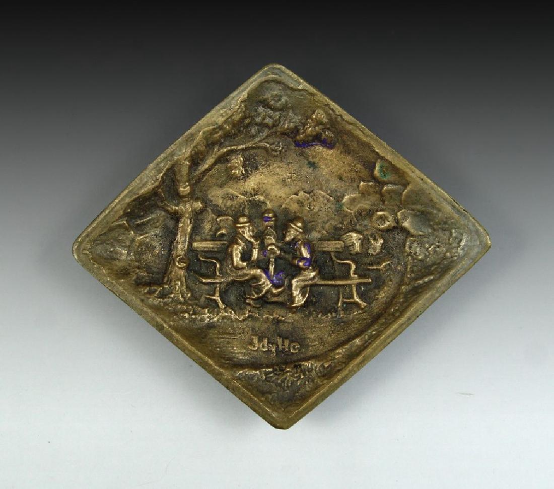 Ashtray with Jewish Figures: A bronze ashtray with a relief of three Jewish men sitting on a bench and secretively talking. Dimensions: 15X13 cm. Signed: Jdylle.