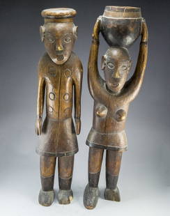 African Wooden Sculptures: A pair of African wooden sculptures, carved in the form of a man and woman. Height: 70-73 cm, flaws and missing parts.