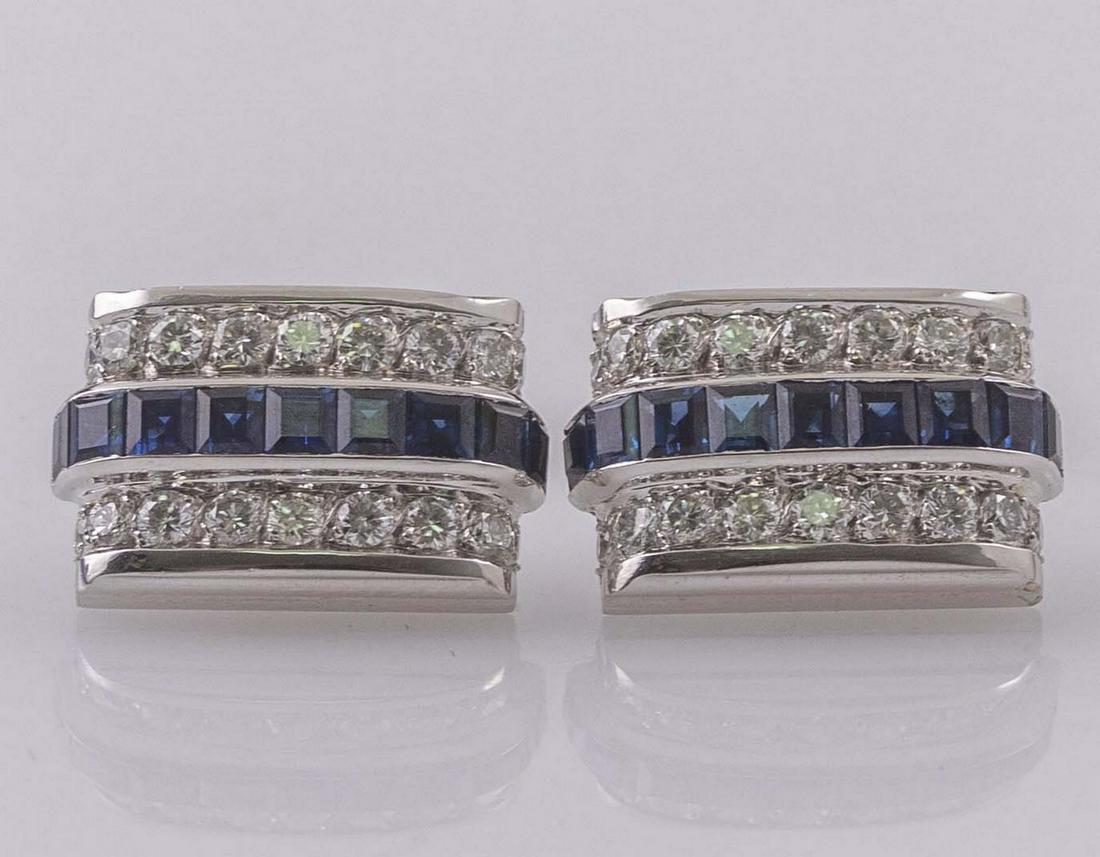 Pair of Platinum Cufflinks, Piaget: Pair of platinum cufflinks by Piaget. Set with sapphires and 18 diamonds of approx. 0.03-0.04 ct each. Dimensions: 18X12 mm. Total weight: 15 grams. Marked.