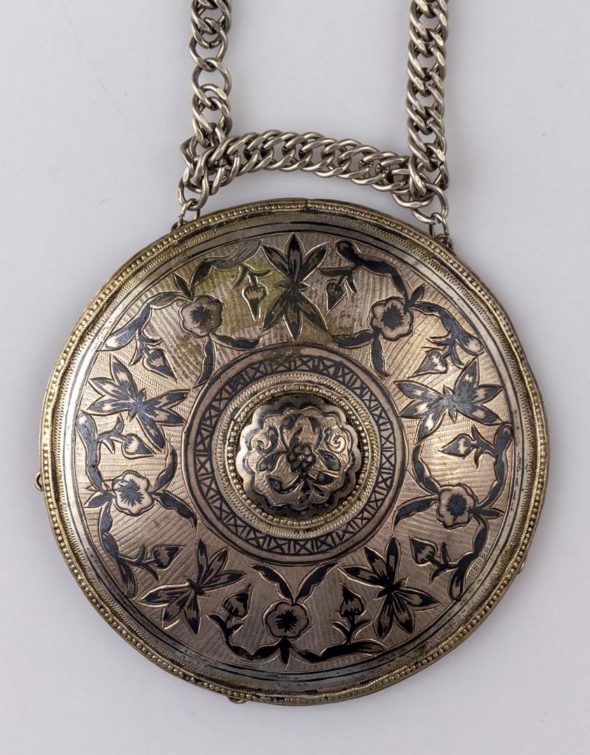 Necklace with Ethnic Silver Pendant: Ethnic silver and niello pendant, probably Caucasian, decorated with floral motifs. On a metal chain. Length: 42 cm. Diameter of pendant: 10 cm. Weight: 116 grams. Unmarked, silver tested.