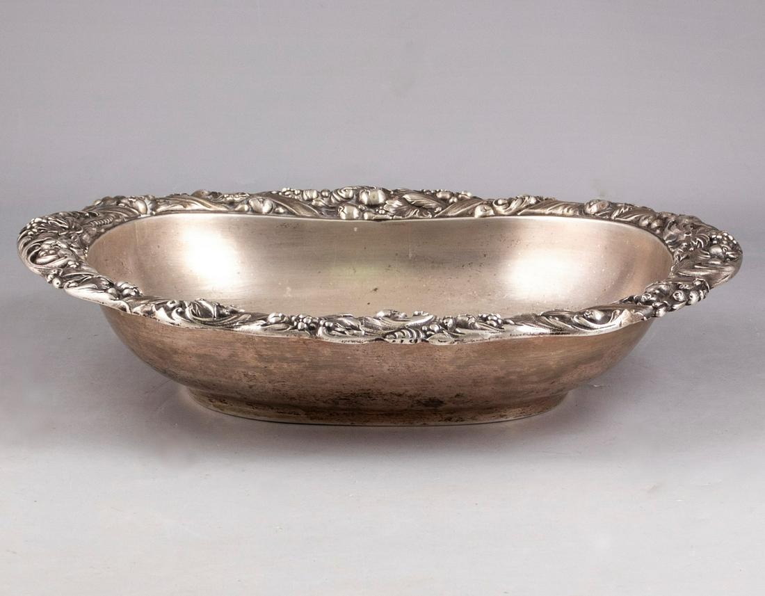 German Silver Bowl: A German silver bowl decorated with embossings. Dimensions: 6X32X26.5 cm. Weight: 985 grams. Hallmarked.