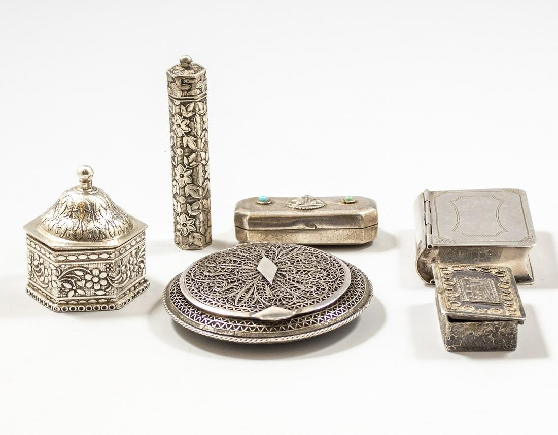 Silver Tobacco/ Pill Boxes: Lot of six silver pill/tobacco boxes. Including one with filigree work, one shaped as a book and others with engravings and embosses. Length/diameter: 4/5-7 cm, total weight: 196 grams. Five are marke