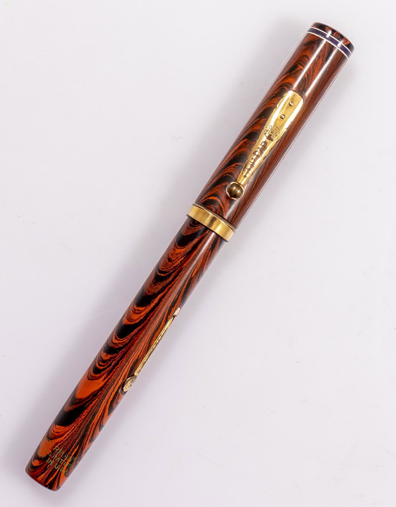 Waterman's 7 Fountain Pen: 1920's Waterman's Fountain pen, model 7, Red ripple hard rubber, Purple band. Size: 5.6" (14.3 cm). 14K gold purple keyhole nib, F. VG external condition with some wear to gold plating, nib in excelle
