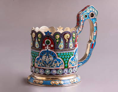 Silver and Enamel Cup Holder: 84 Silver cup holder. Decorated with floral pattern in enamel. Height: 11.5 cm. Inner diameter: 6.5 cm. Weight: 272 grams. Bears Pseudo Russian silver marks.