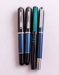 Pelikan Pens: Lot of 4 Pelikan pens, including 3 fountain pens and rollerball pen. Modern models including 60, Blue/black. Size: 5.1"-5.4" (13-13.8 cm). Steel nibs, various sizes. Overall very good condition.