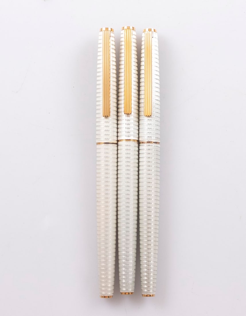 Pilot Deluxe Fountain Pens: Lot of 3 Pilot Deluxe fountain pen. Metal body and cap with Guilloche work. Section in white, Jewels in Burgundy. Size: 5.2" (13.2 cm). 14K-18K gold nibs, F. Mint, NOS.
